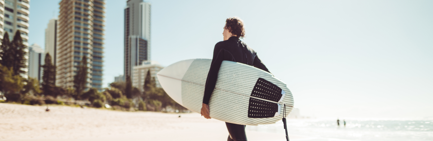 Surfer Walking In Surfers Paradise Beach In Australia